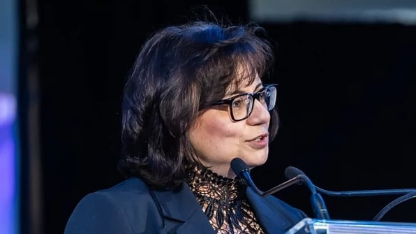 Soula Chronopoulos speaking at a podium
